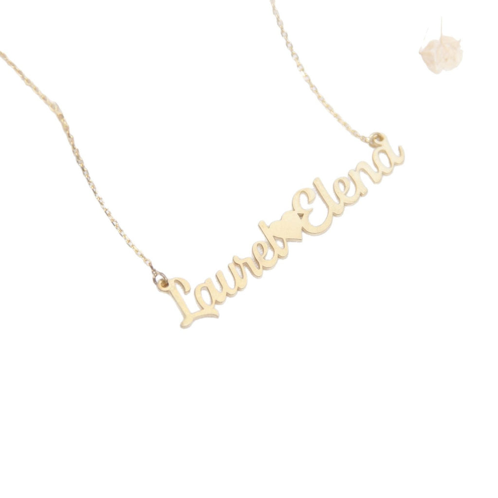 Gold double-name necklace with heart charm on white background