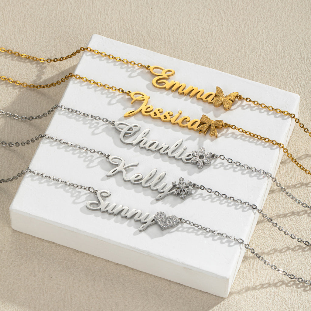 Five name necklaces with different charm accents