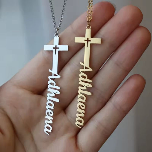 Gold and silver cross name necklaces side by side
