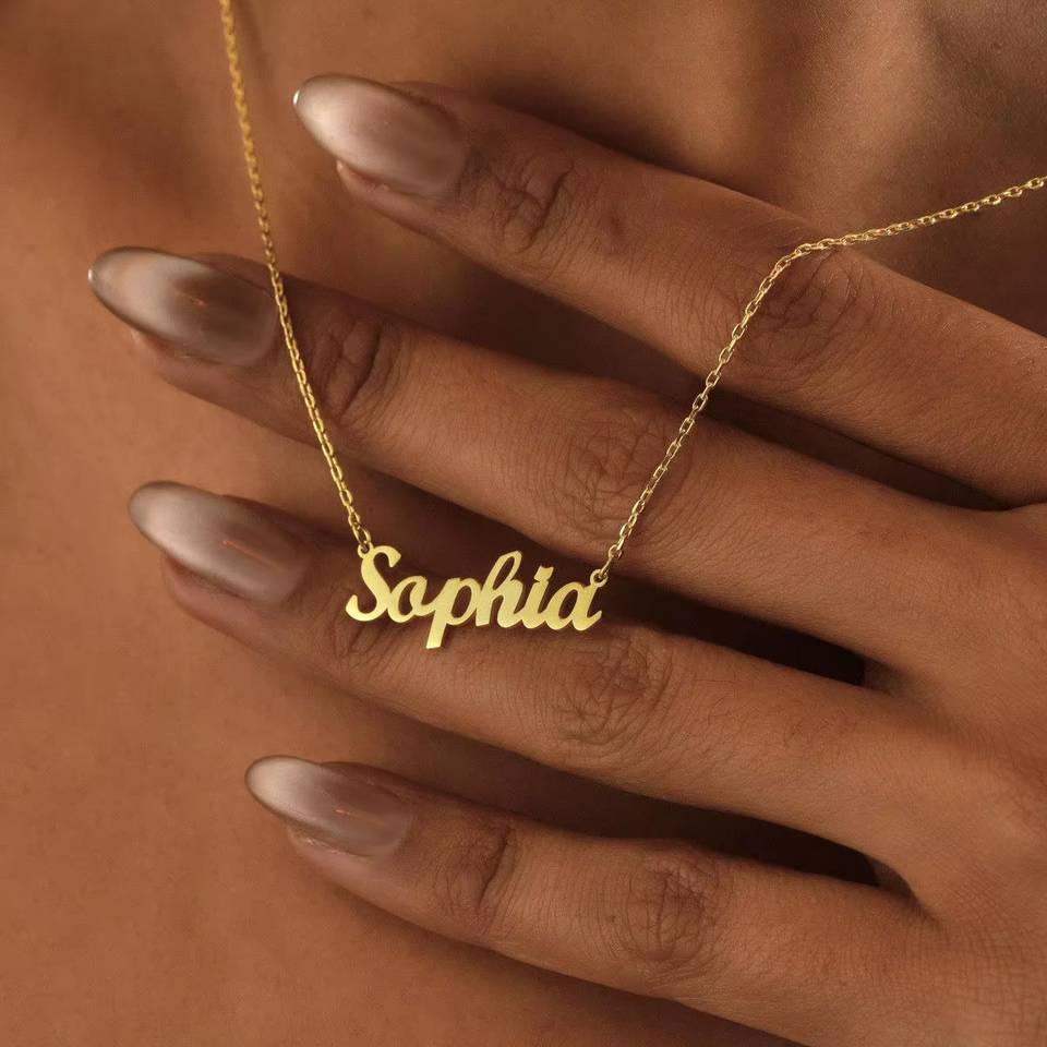 Model wearing gold script name necklace