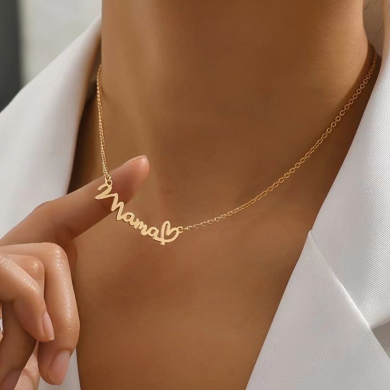 Gold Mama heart script necklace worn on neck