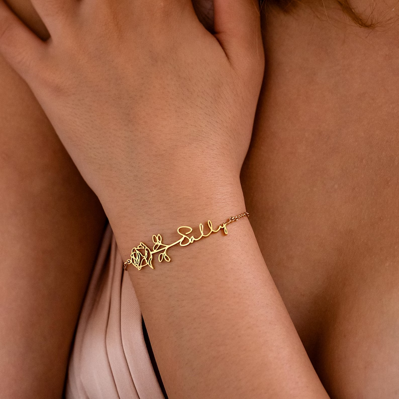 Model wearing gold flower vine custom name bracelet