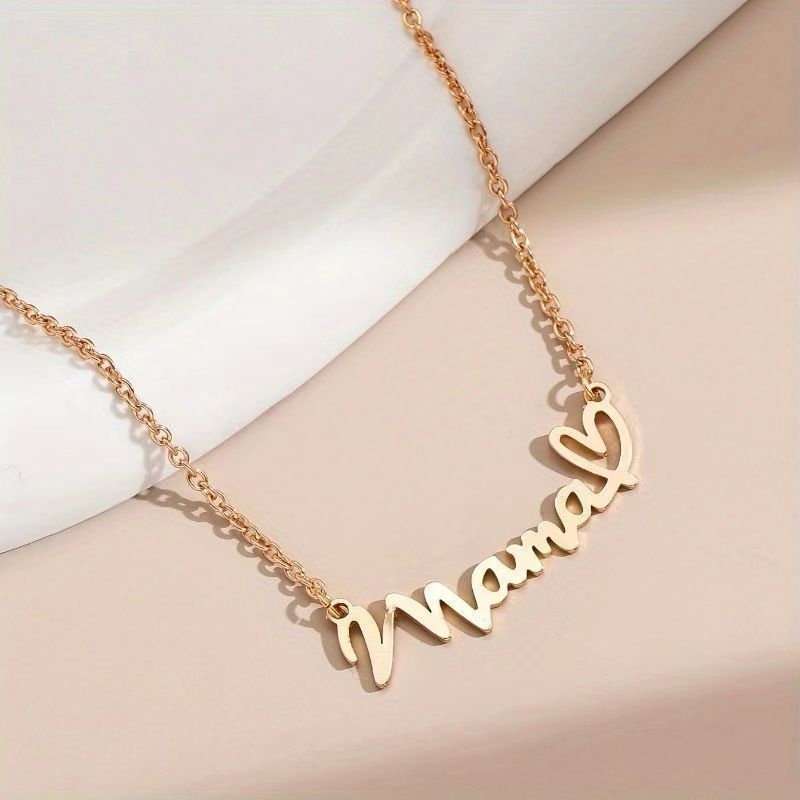 Close-up of gold Mama heart pendant
