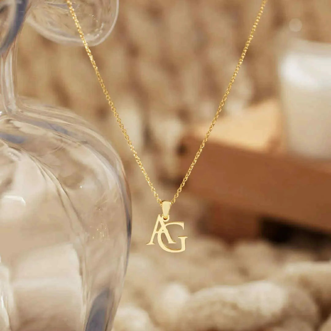 Gold two-letter initial pendant necklace close-up