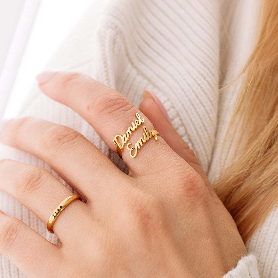 Gold double-name ring worn on hand